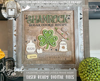 a st patrick's day themed sugar cookie recipe on a wooden sign in a rustic farmhouse style featuring a shamrock sugar cookie, cute flour sack, eggs, butter, whisk and rolling pin. 